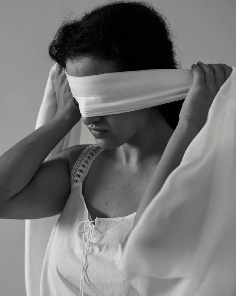 Black and white photo of a blindfolded woman, from the Sneha: A Ray of Hope postpartum depression campaign