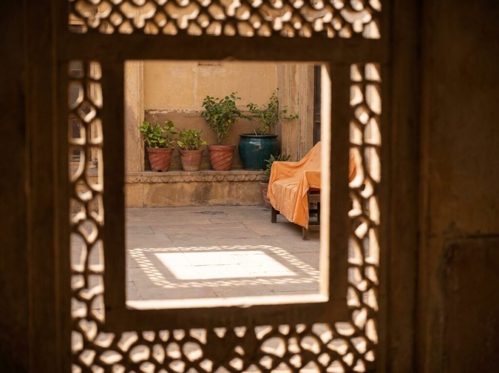 A square stone window framing a calm courtyard